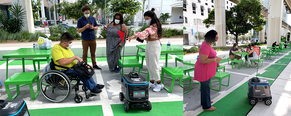 A group of people standing around with green chairs.