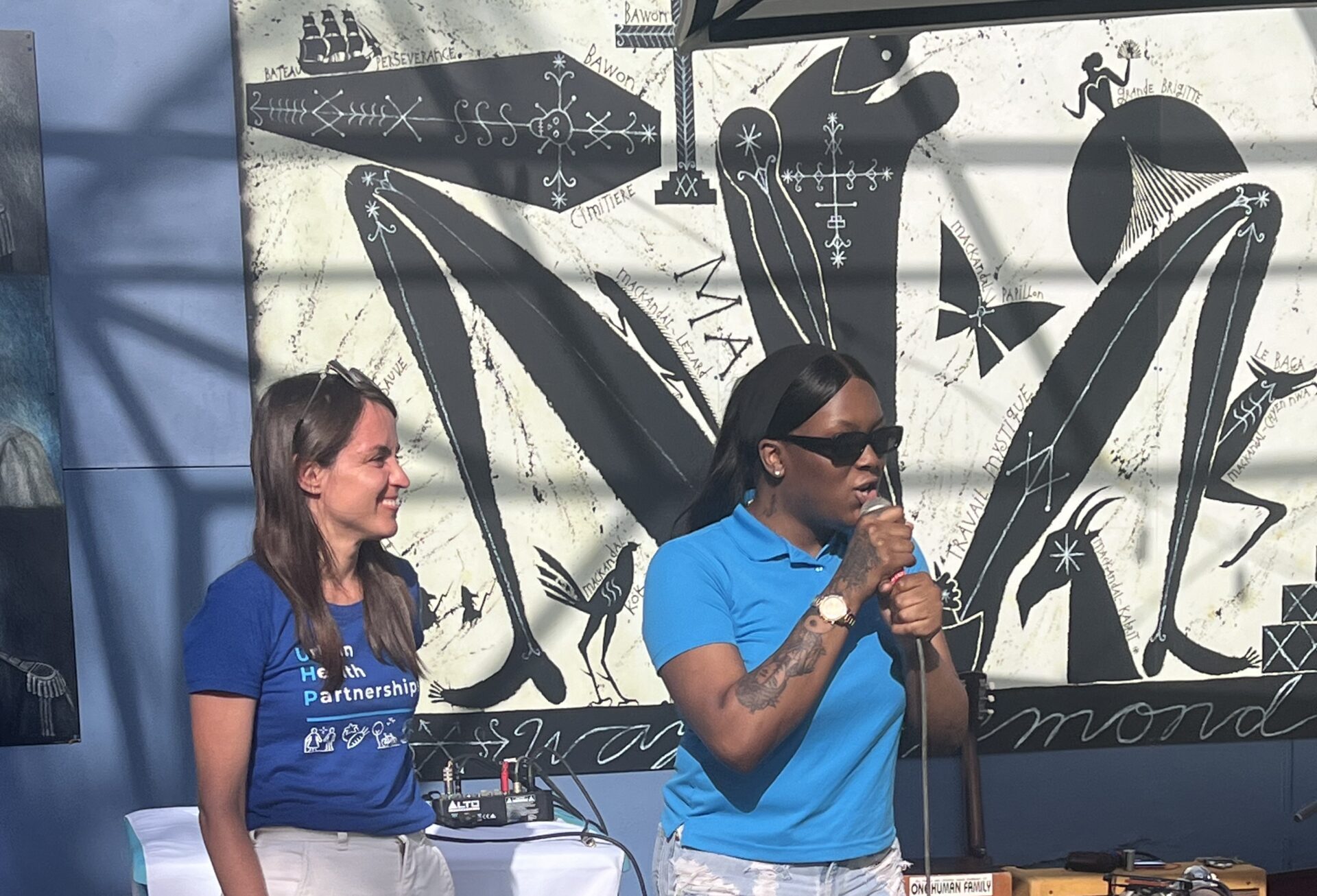 Group of people walking on a sidewalk.